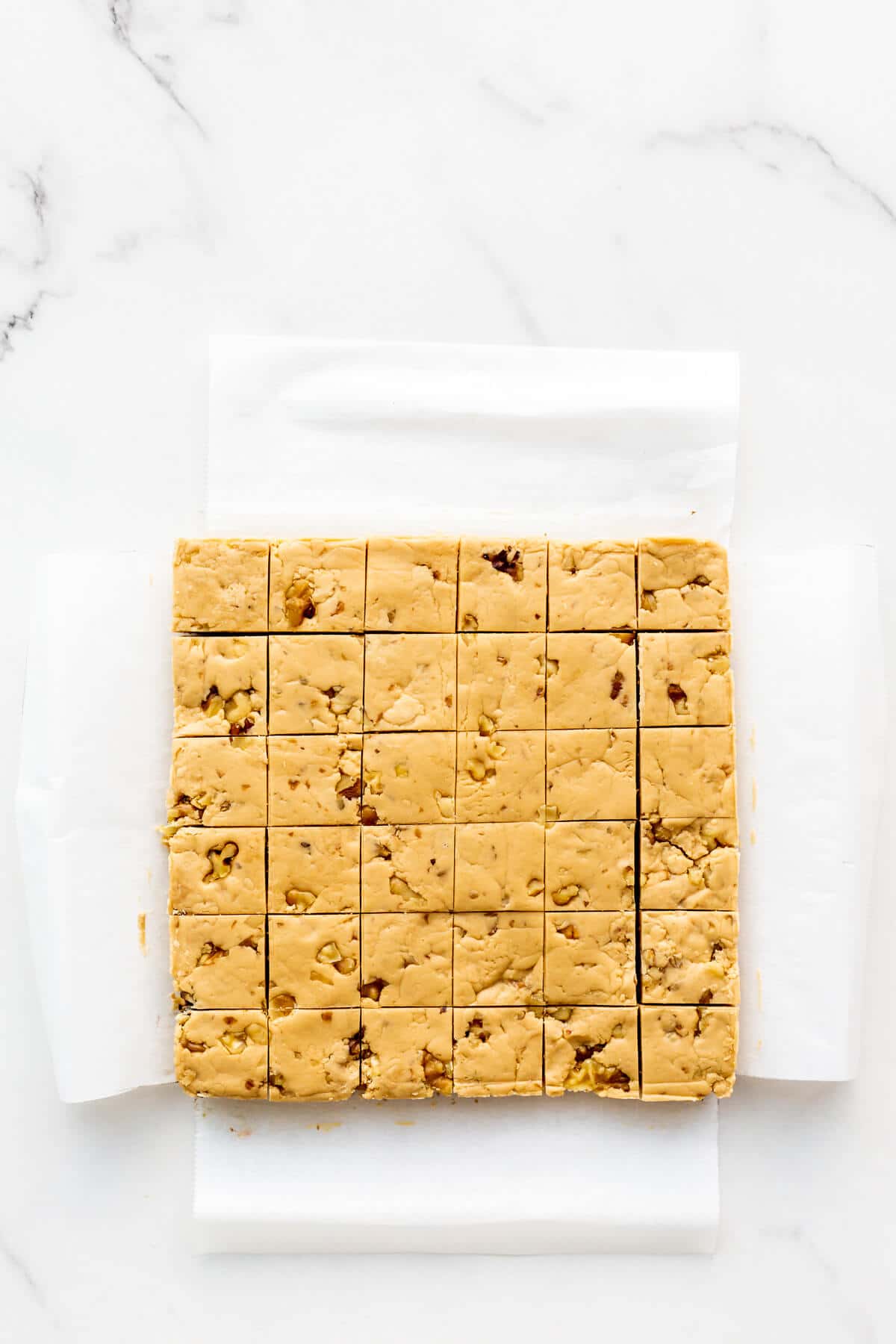 A pan of maple fudge cut into squares.