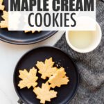 A plate of maple cream cookies with a glass of milk.