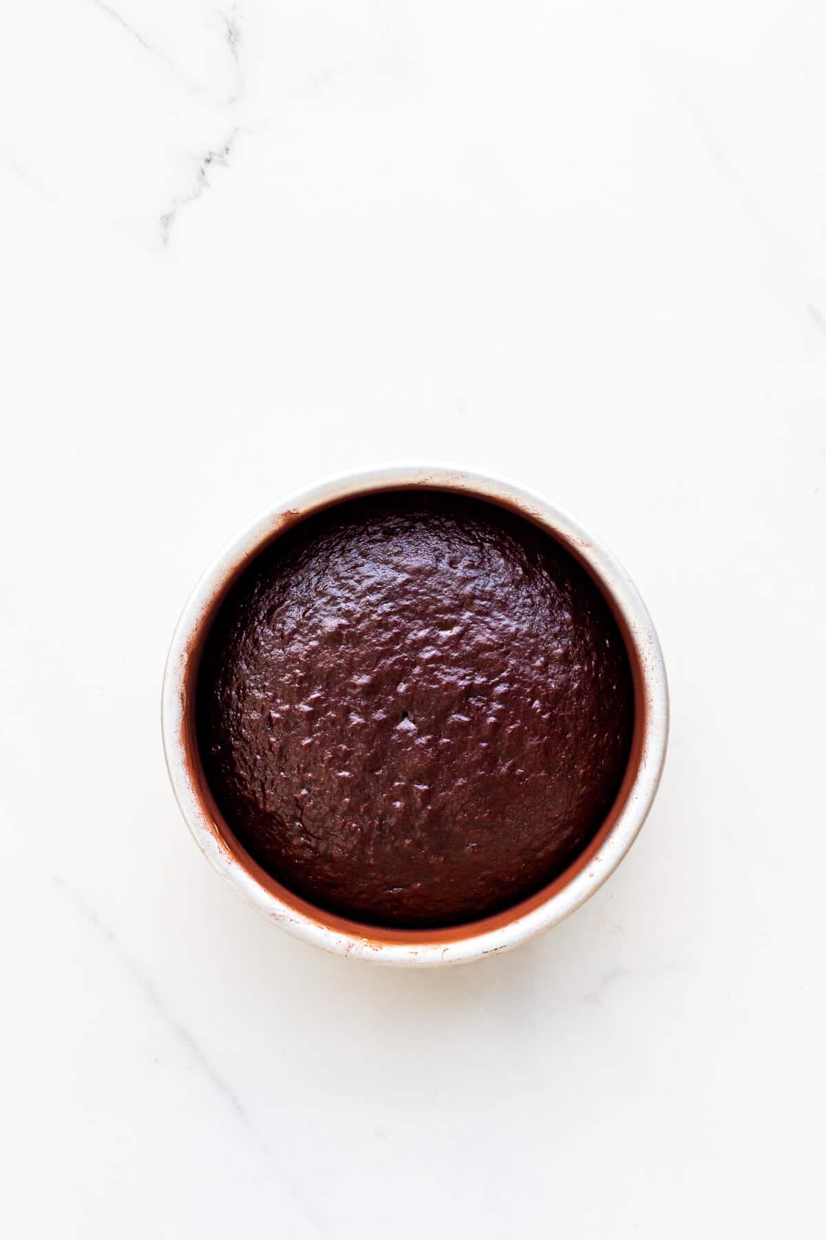 A freshly baked layer of chocolate cake for a birthday cake.