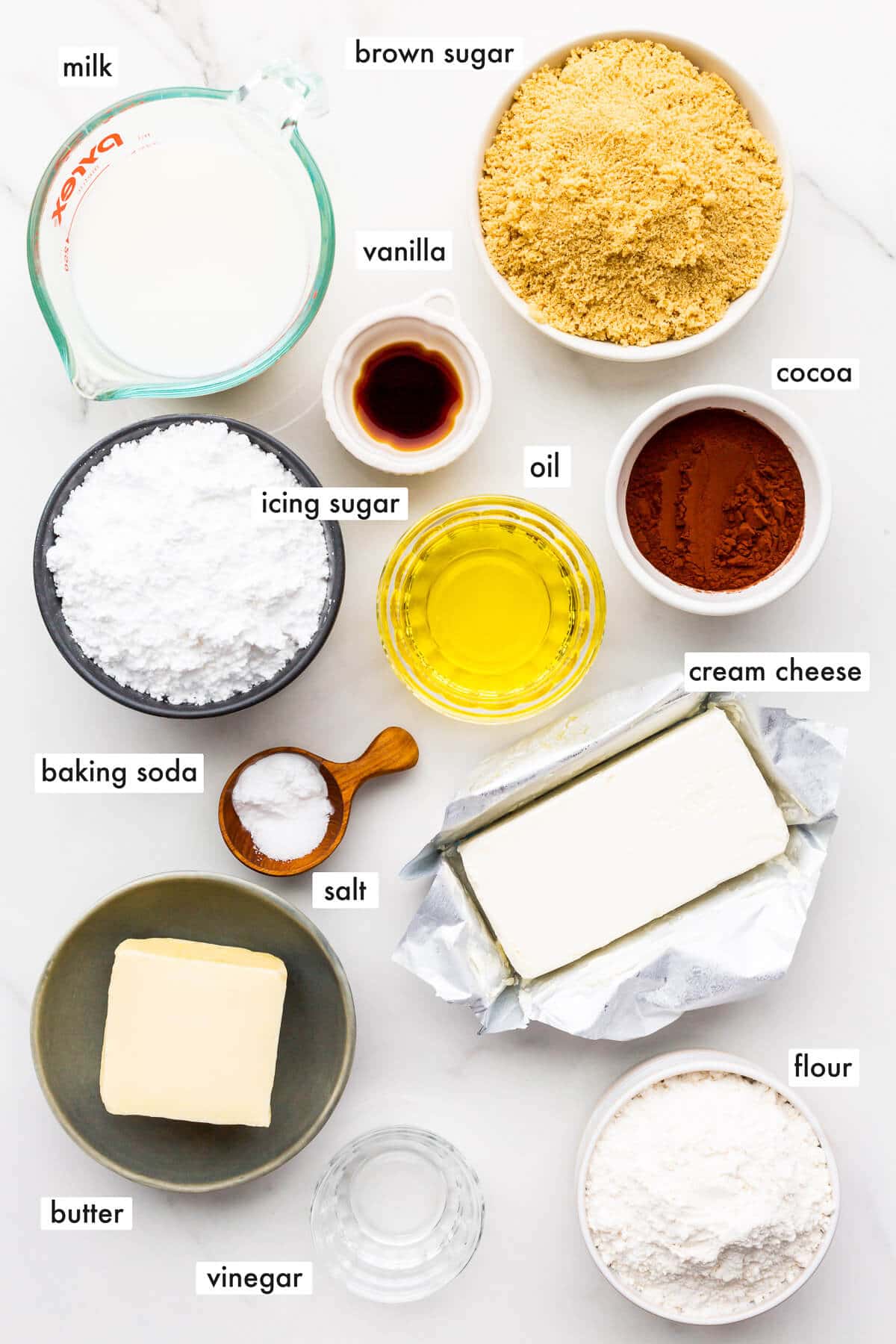 Ingredients to make an eggless chocolate cake with cream cheese frosting.