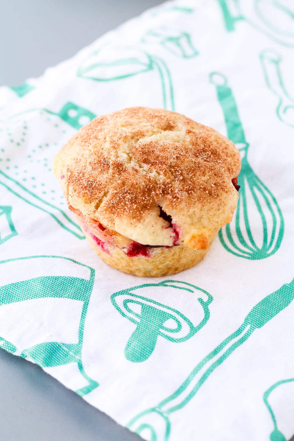 Freshly baked plum muffin topped with cinnamon sugar.