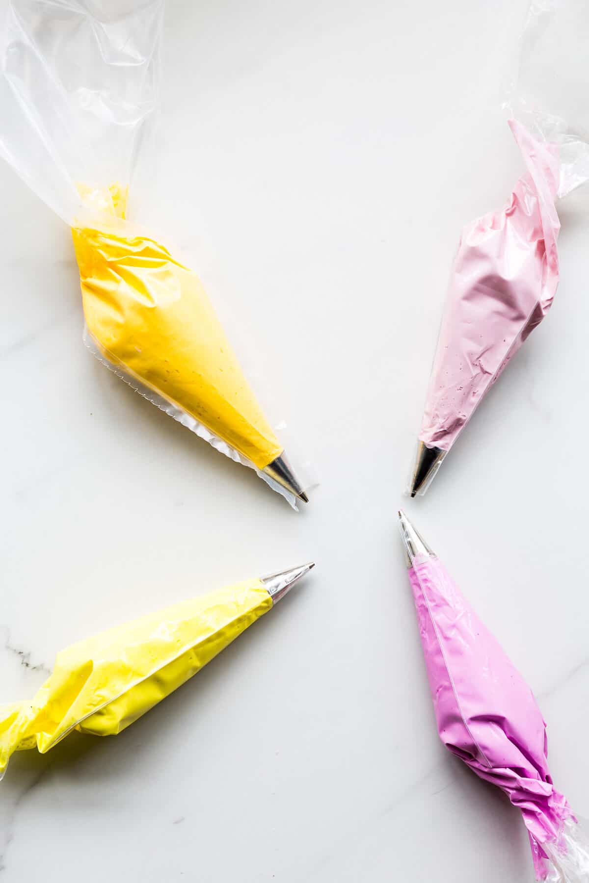 Piping bags filled with coloured royal icing to make homemade sprinkles.
