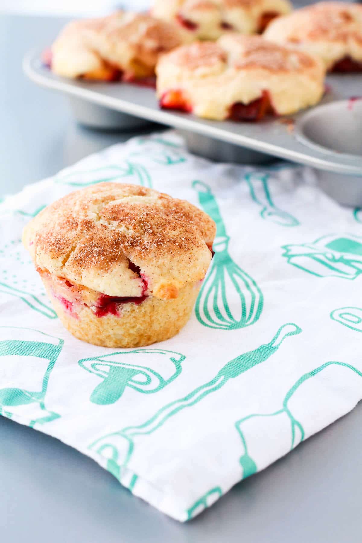 Freshly baked plum muffin topped with cinnamon sugar.