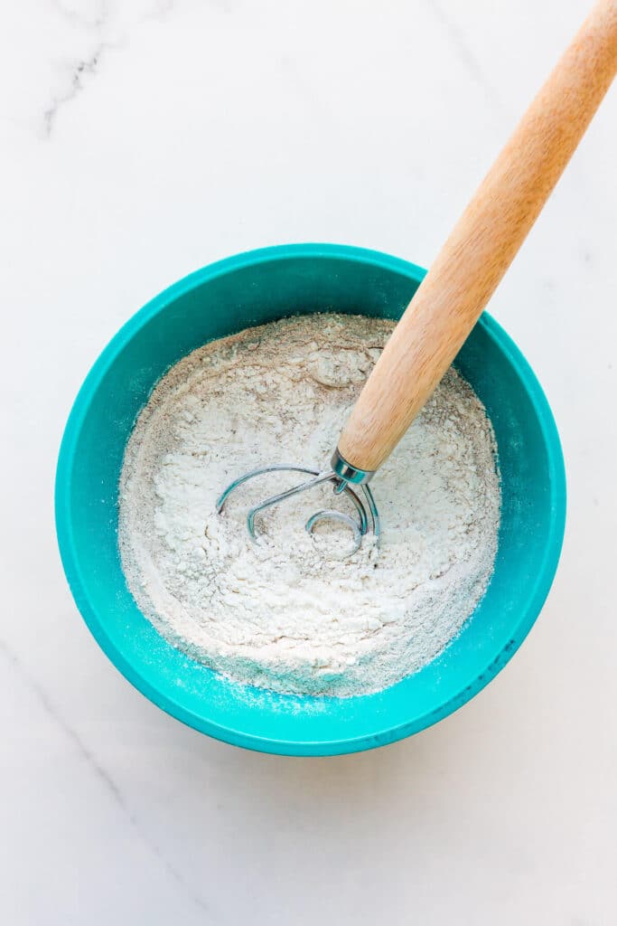 Whisking flour, buckwheat flour, and salt for buckwheat cookies.