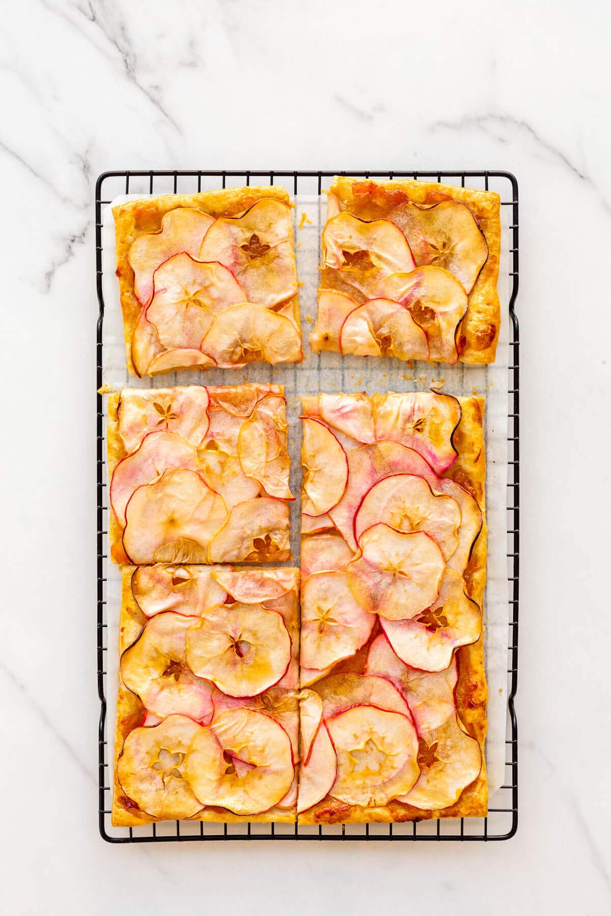 French apple tart cut into squares to serve.