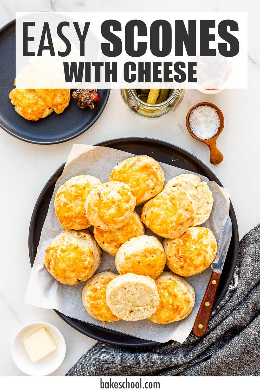 A plate of savoury cheese scones ready to be served with butter and spicy jam.