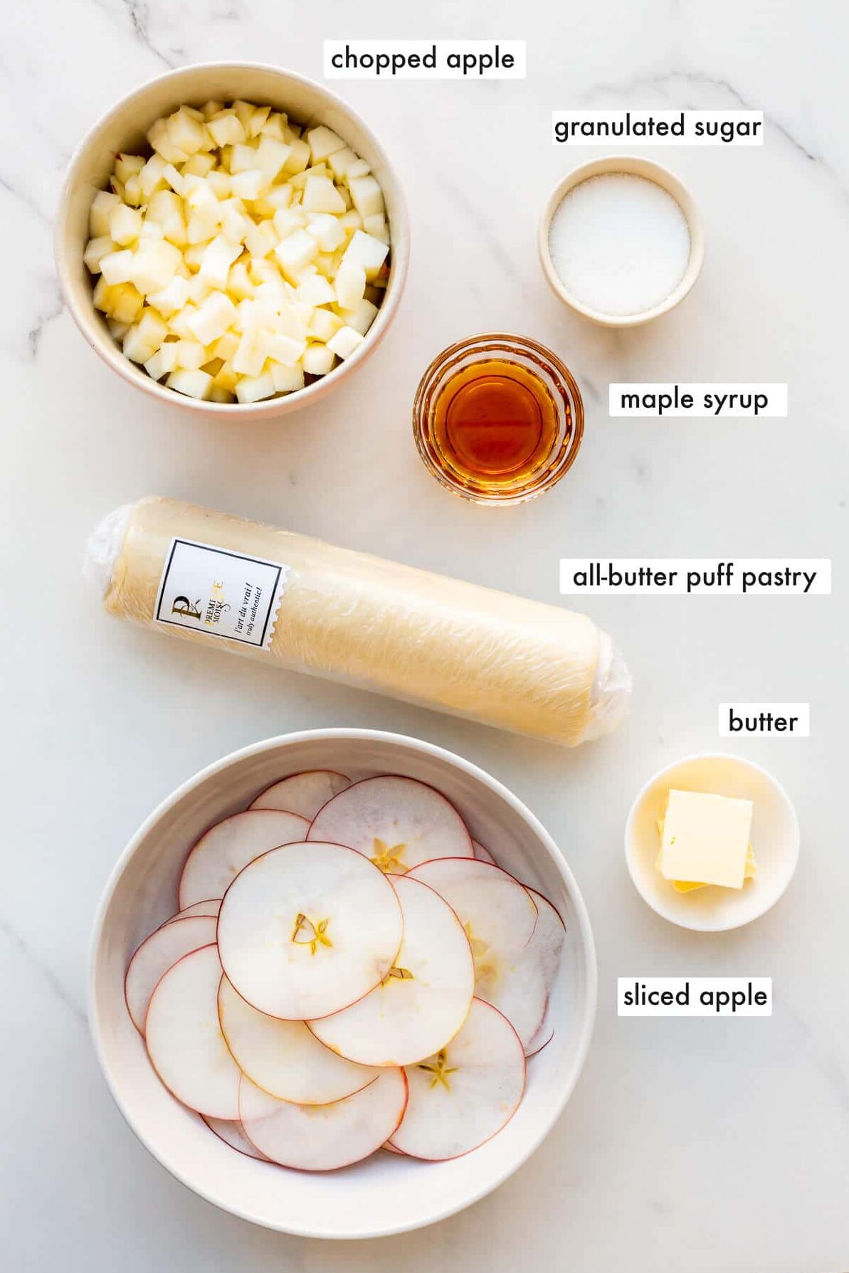 Ingredients to make a puff pastry apple tart, prepared and ready to be assembled.