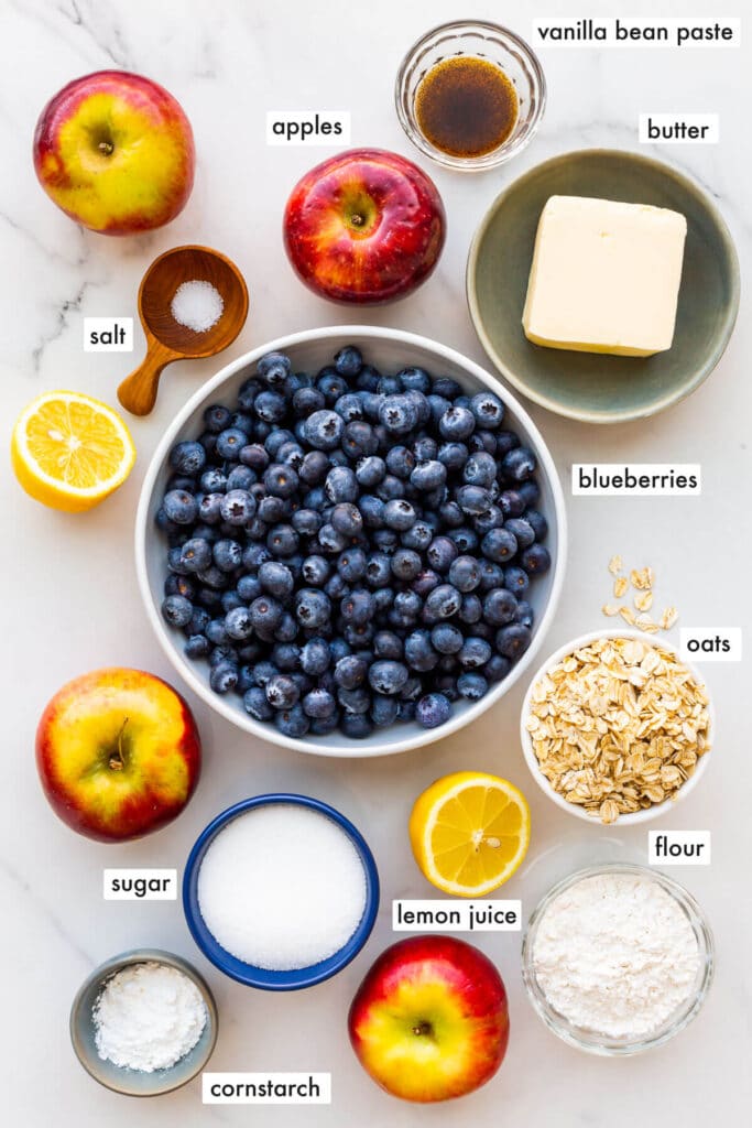 Ingredients to make an apple and blueberry crumble from scratch, measured out and ready to mix and bake.