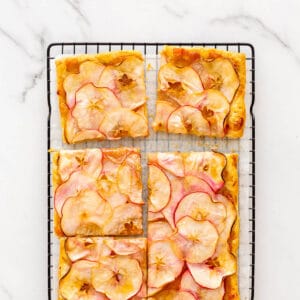 Puff pastry apple tart cut into squares to serve.