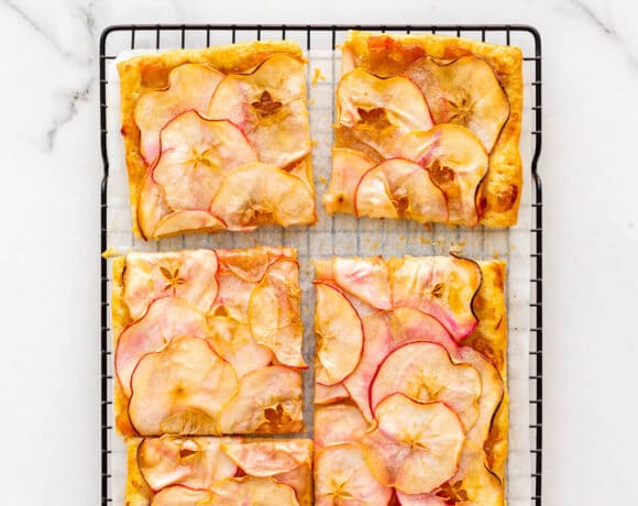 Puff pastry apple tart cut into squares to serve.
