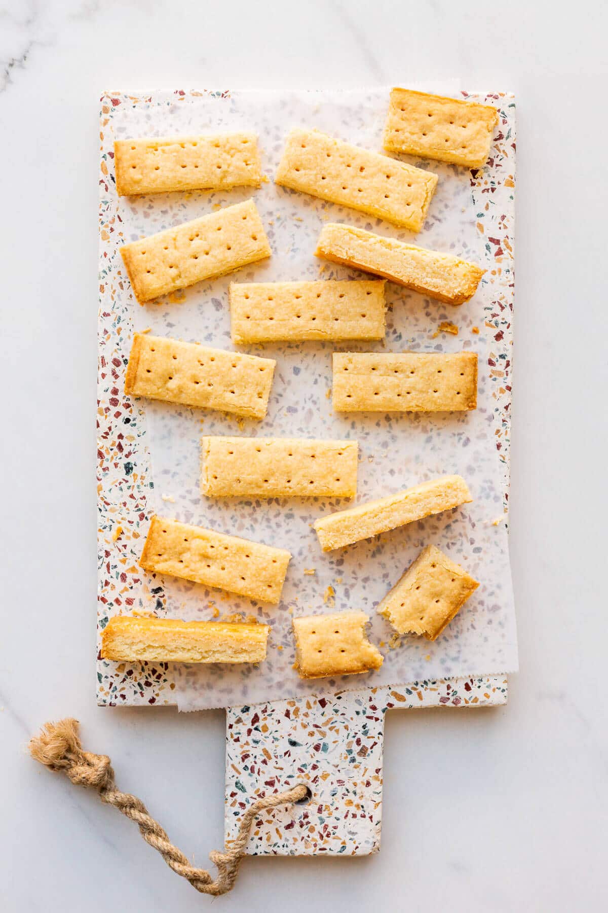 Shortbread cookie sticks on a terrazzo platter.