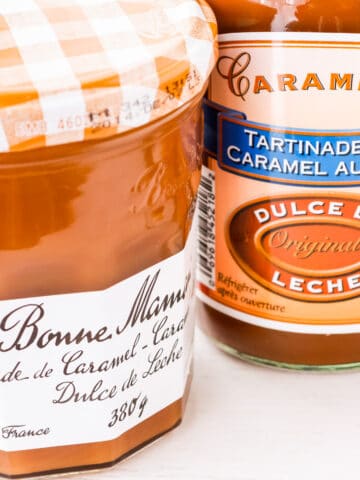 Two jars of dulce de leche from two different brands: Bonne Maman and Caramella.