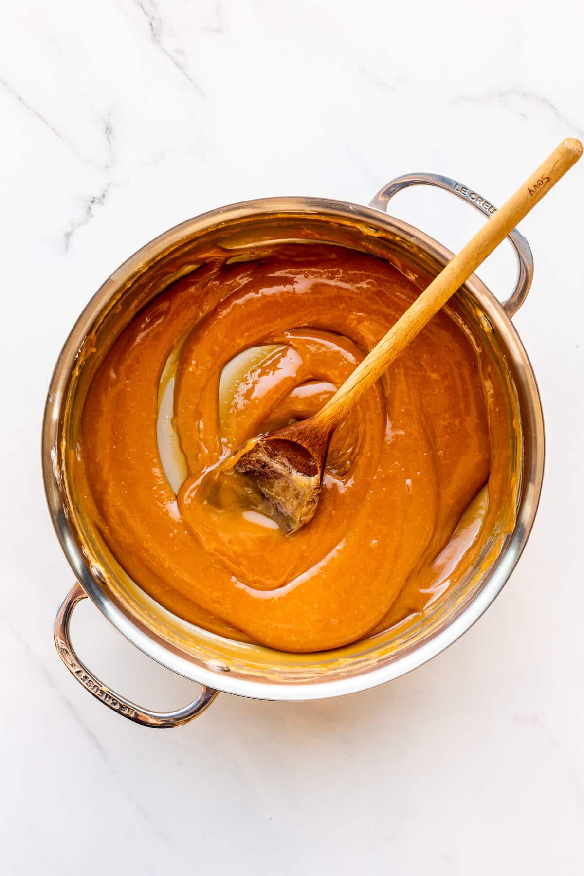 A pot of homemade dulce de leche freshly made and ready to transfer to a jar.