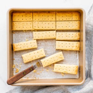 Shortbread cookies cut into sticks in a square pan.