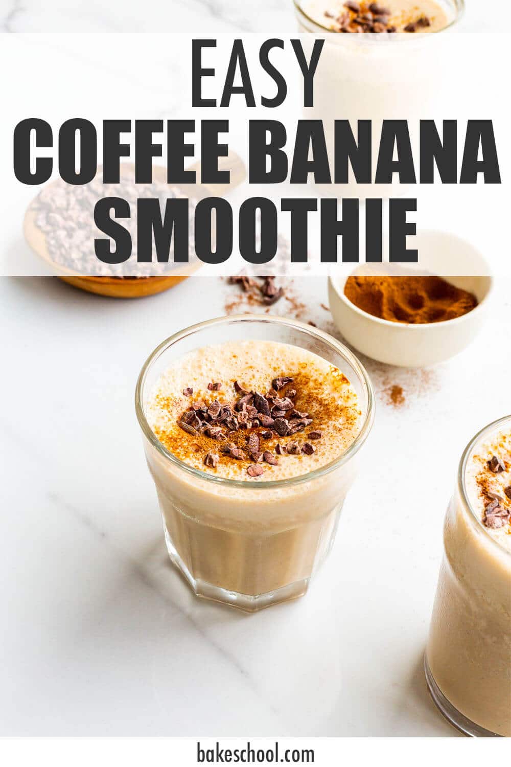 Glasses of coffee banana smoothie garnished with cocoa nibs and espresso powder.