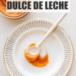 A spoonful of thick, gooey dulce de leche on a plate.