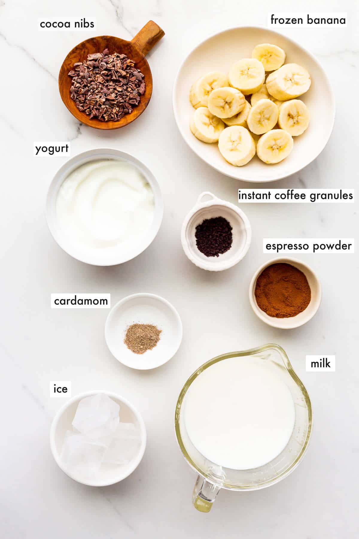 Ingredients to make a banana smoothie with coffee in it, ready to be blended.