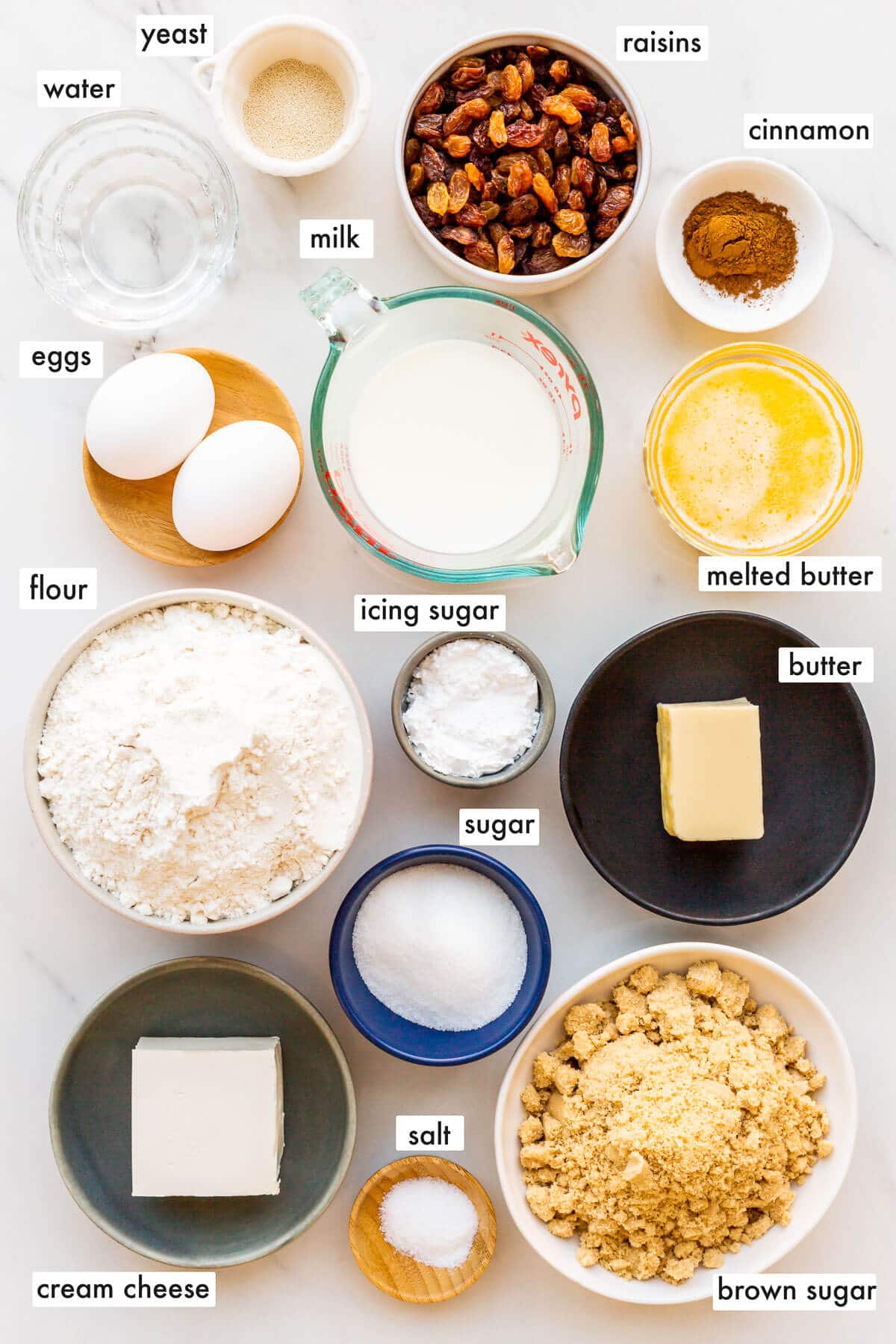 Ingredients to make cinnamon rolls with raisins measured and ready to be mixed.