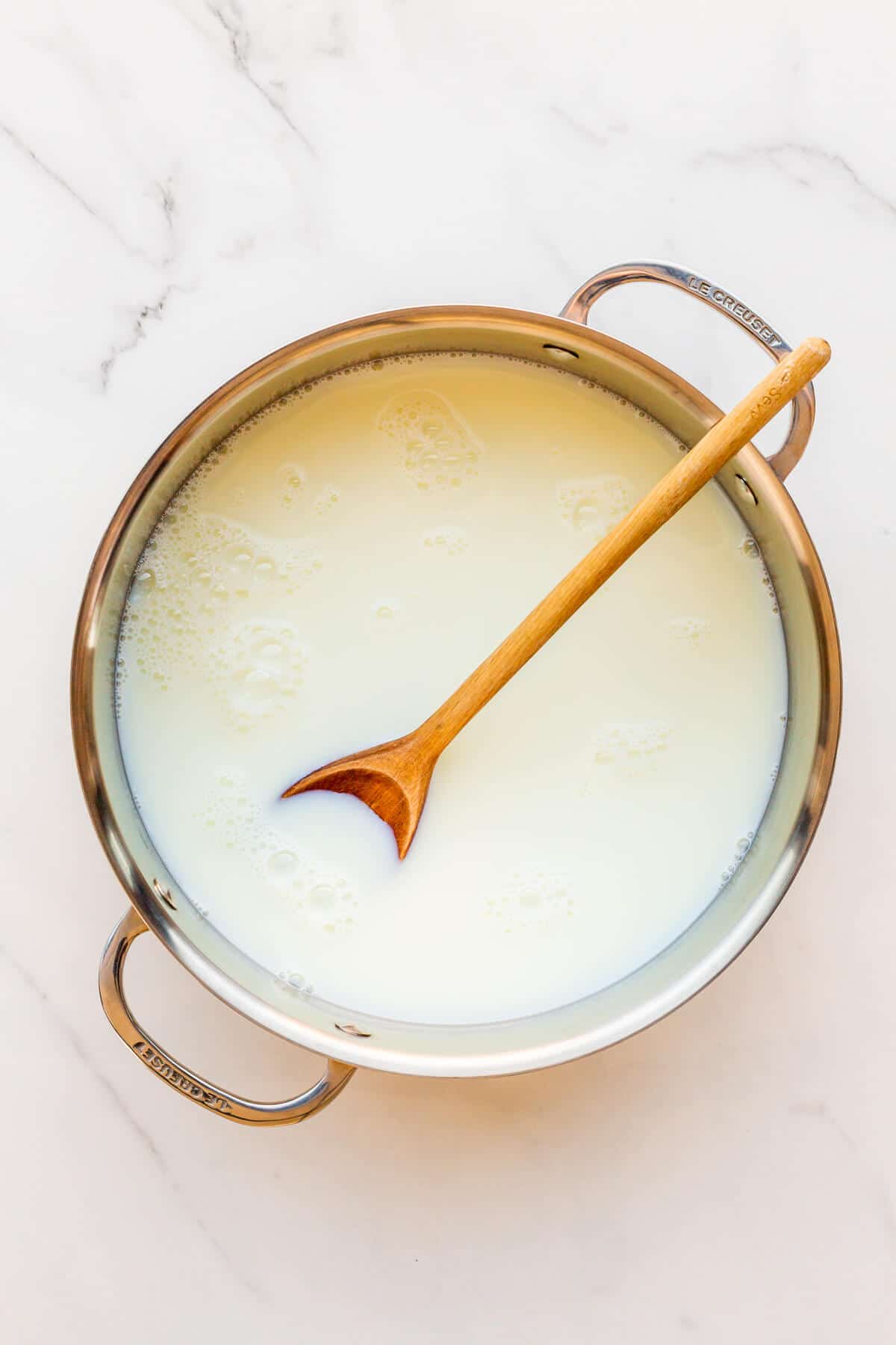 A pot of milk and sugar ready to be cooked to make milk jam or dulce de leche.