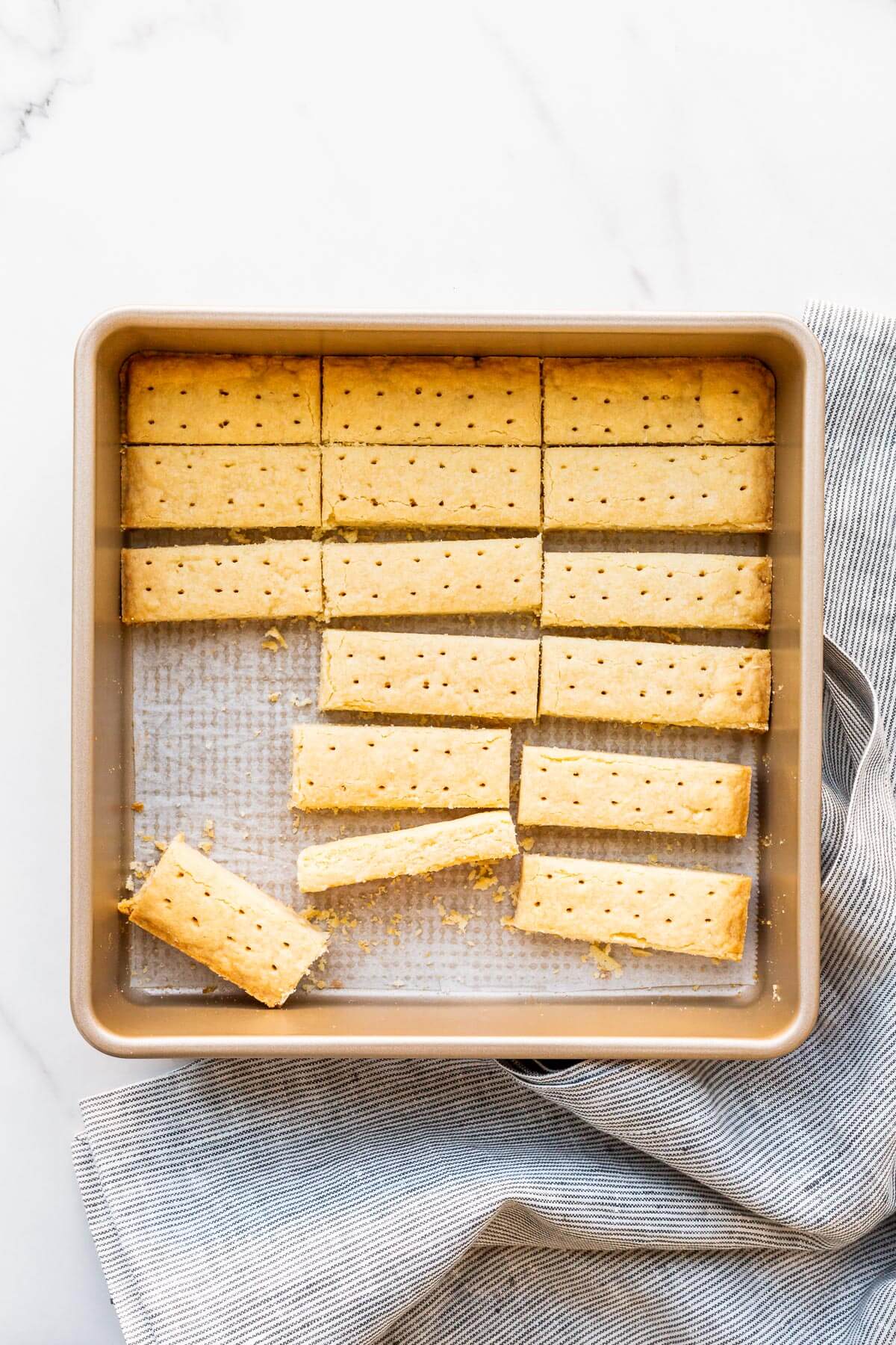 A pan of buttery shortbread cookies cut into sticks.