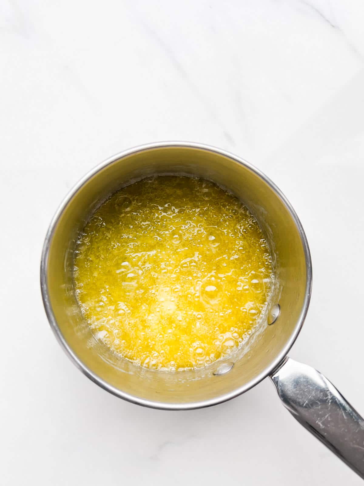 Butter sizzling in a pan to boil off the water and make brown butter.