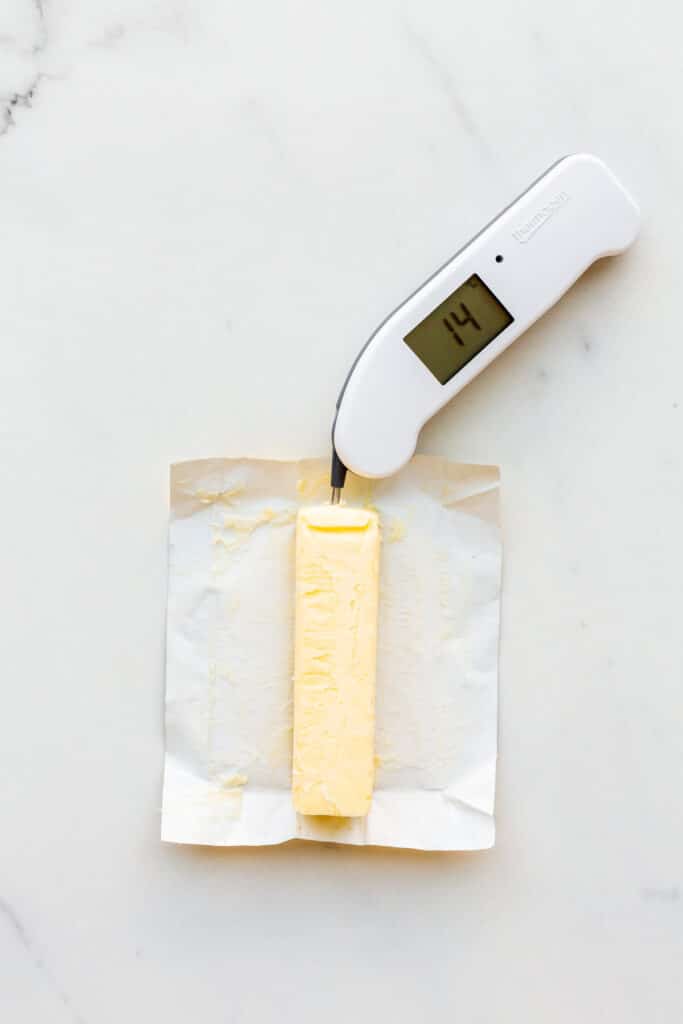 Using a Thermapen to measure the temperature of a stick of cold butter that has been at room temperature for about an hour to soften it.