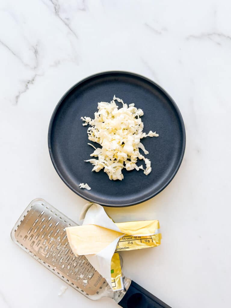 Grating butter to help it warm up and soften faster to make cookies fast.