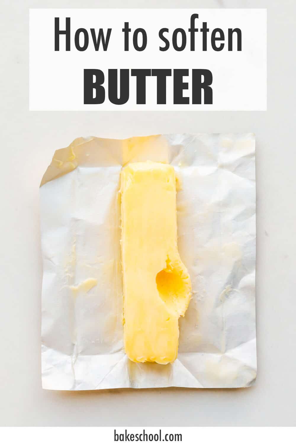 Softened butter with a deep thumbrint on the side to show the pliable texture that it has, which is perfect for baking cookies and cakes.