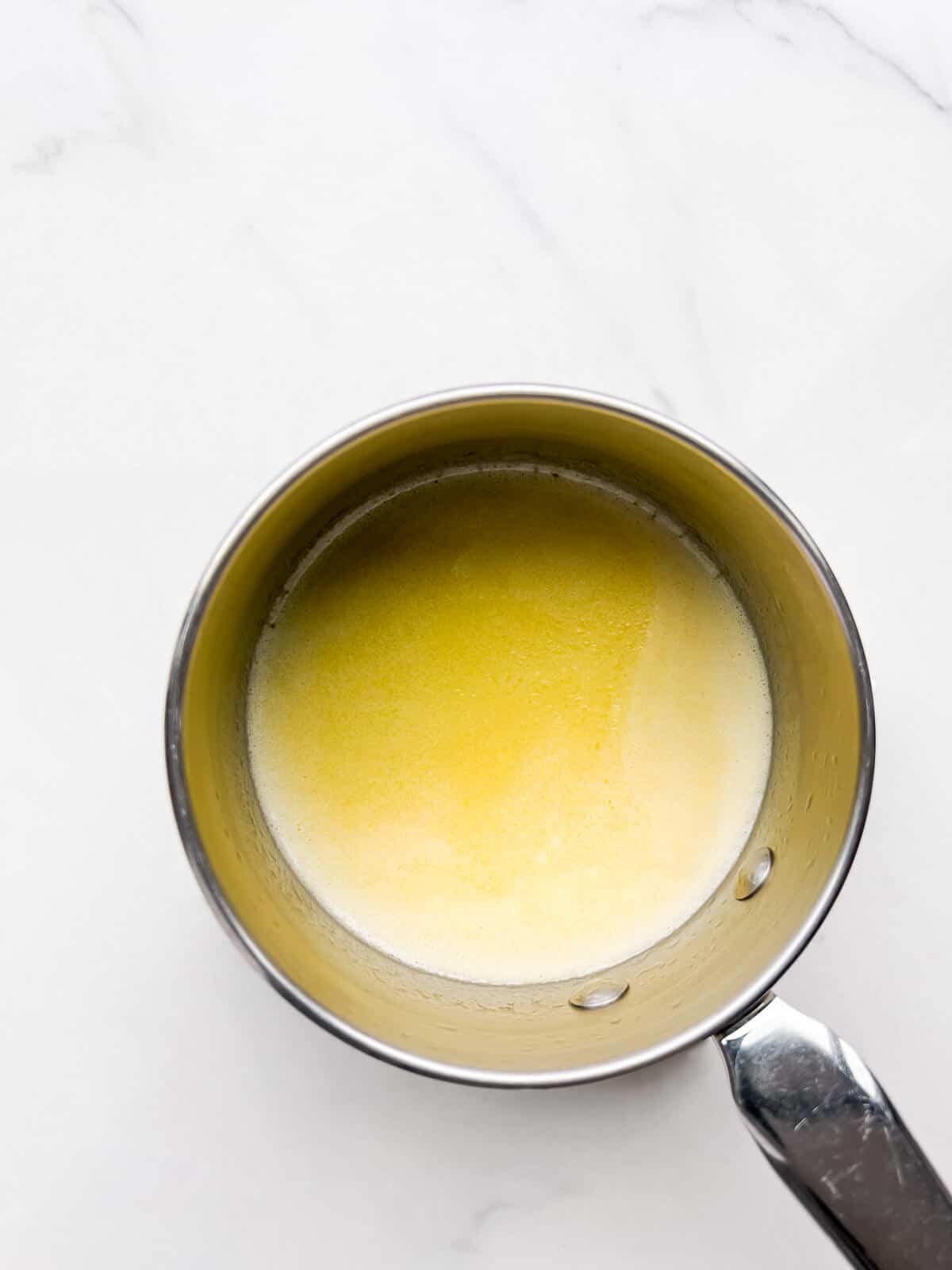 Melting butter in a saucepan to make brown butter.