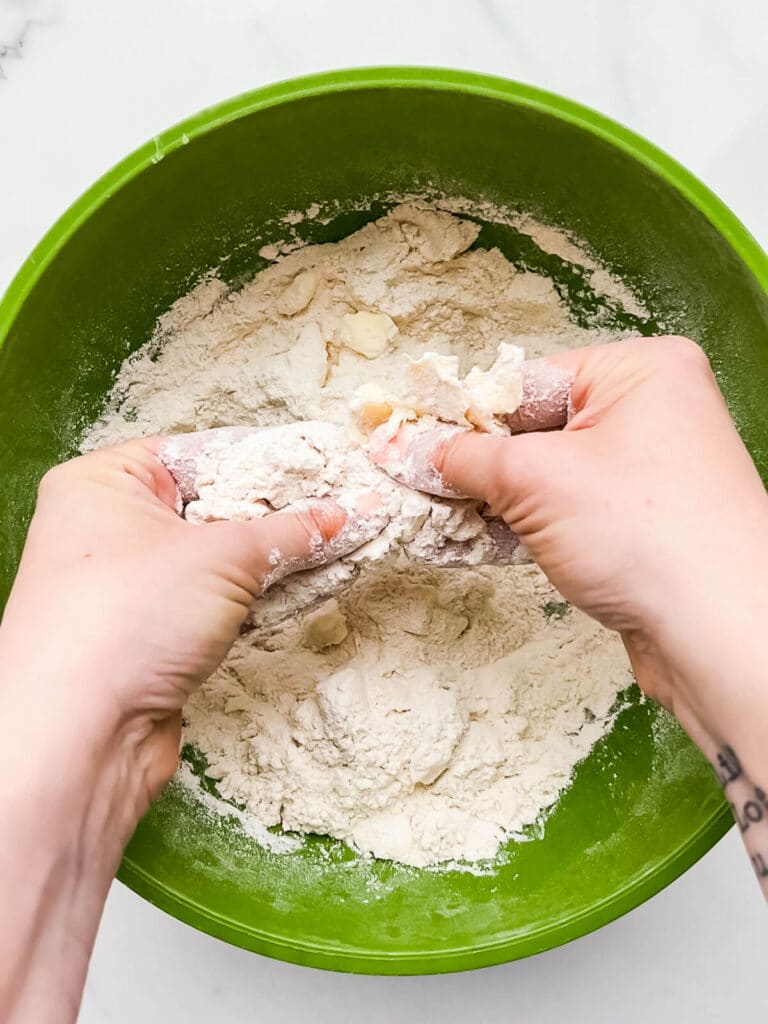 Working butter into flour to make dough for scones.