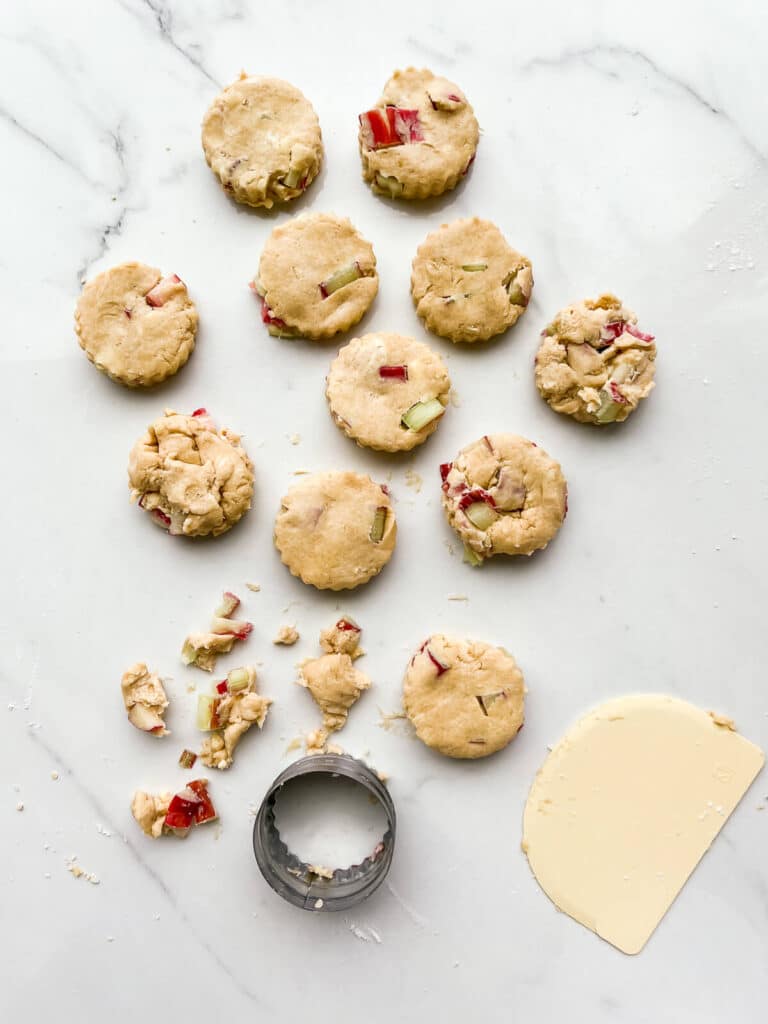 Cutting out scones with a fluted cookie cutter.