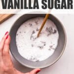 Mixing vanilla bean seeds (caviar) with granulated sugar in a bowl to make vanilla sugar.