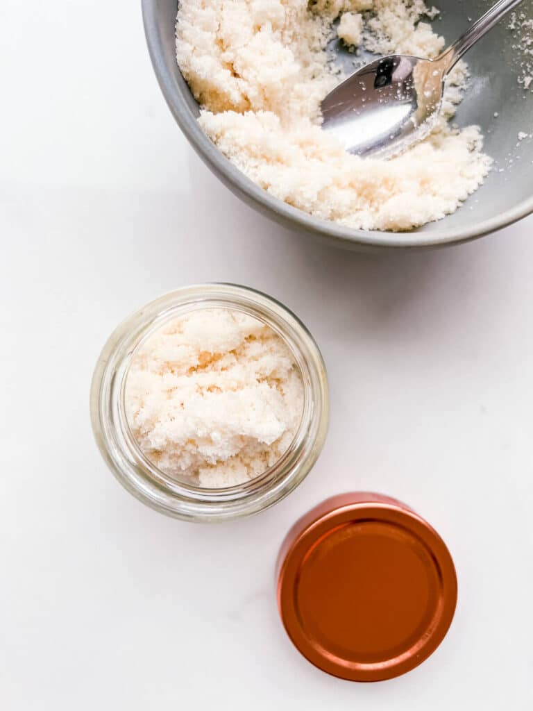 Transferring homemade vanilla sugar to a jar to store it.