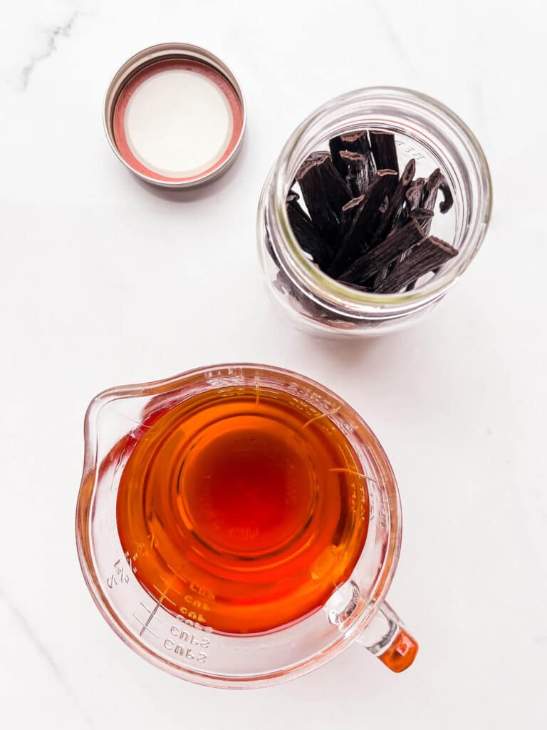 A jar filled with vanilla beans, ready to be extracted with alcohol.