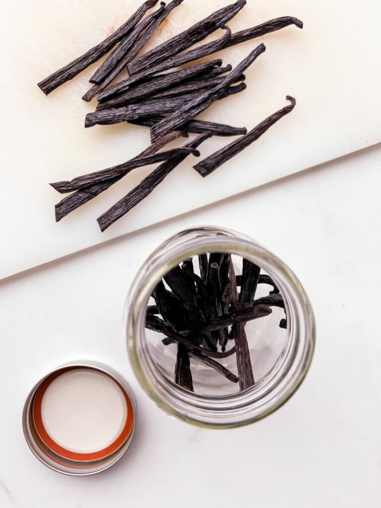 Transferring vanilla beans to a jar to make homemade extract.