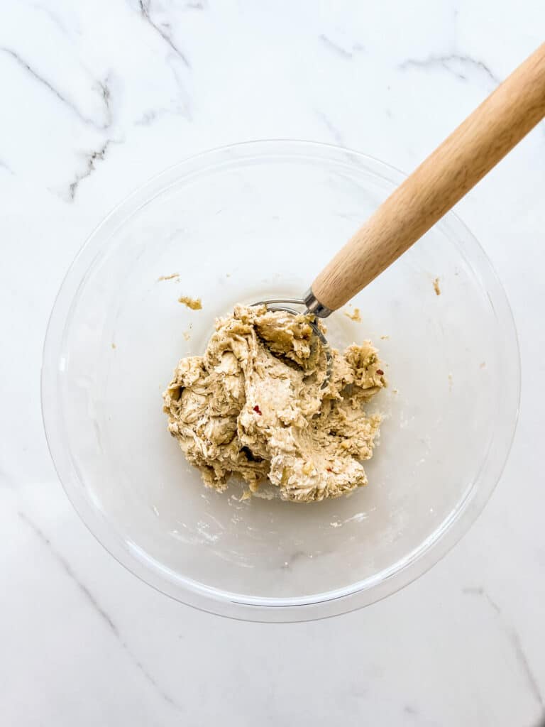 Combining dough in a bowl to make crackers.