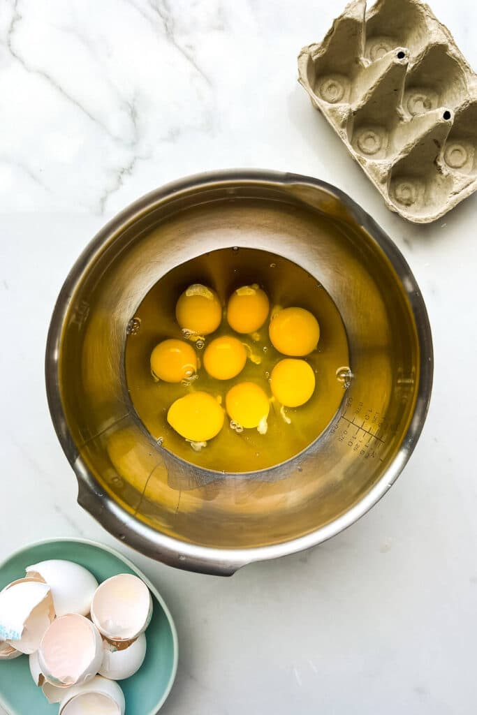 Cracking eggs into a large bowl to make the filling for a big homemade quiche.