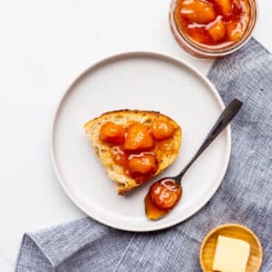 Peach jam served with sourdough bread and butter on the side.