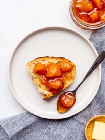 Peach jam served with sourdough bread and butter on the side.