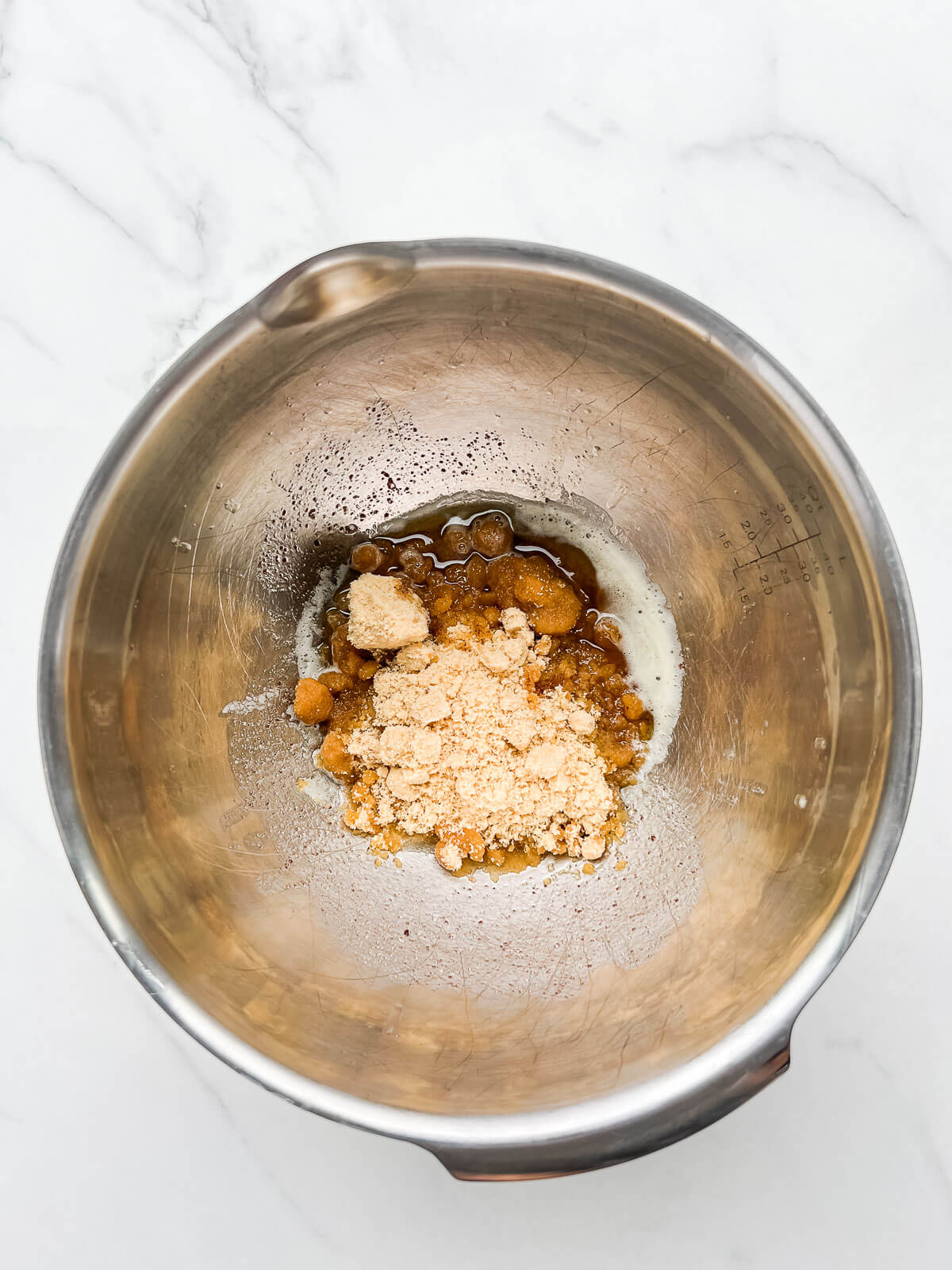Brown butter and brown sugar in a stainless steel bowl.