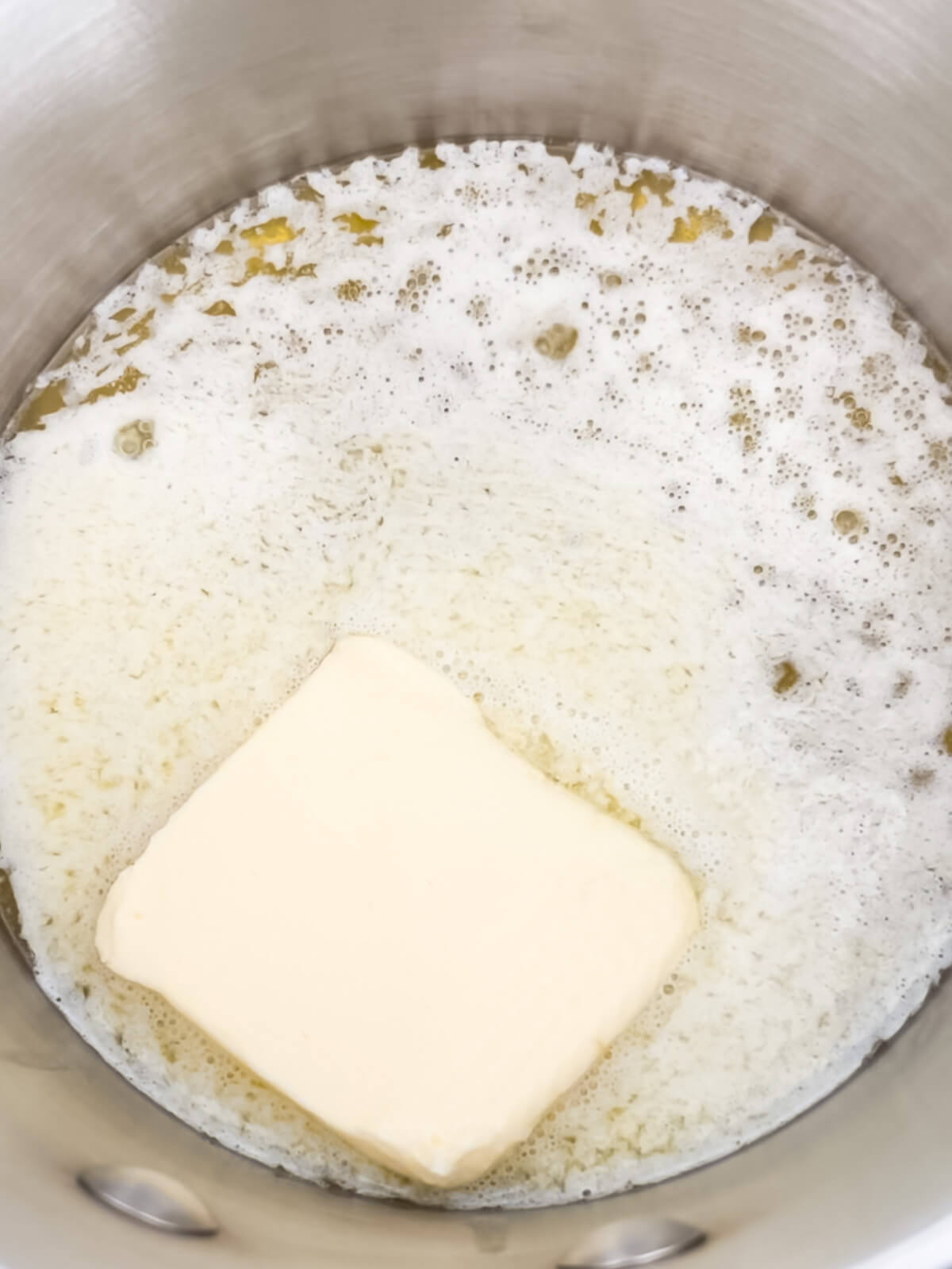 Melting butter in a saucepan to make brownies.