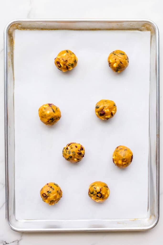 Pumpkin cookies before baking on a parchment-lined sheet pan.