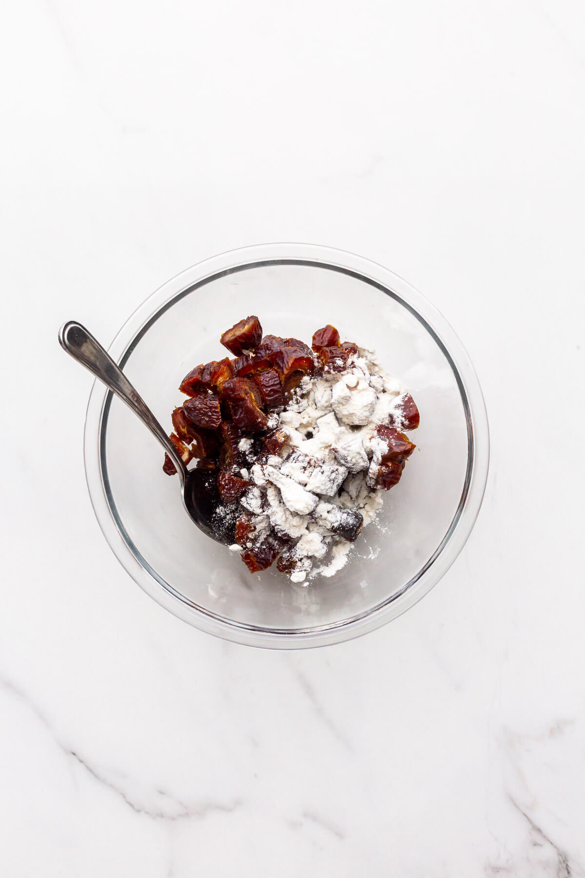 Tossing chopped pitted dried dates with a spoonful of flour to incorporate them in muffins so they don't sink.