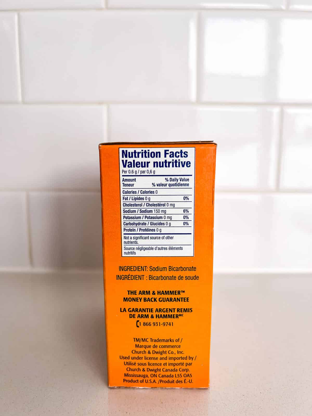 A closeup of the ingredients and nutrition label on a box of baking soda.