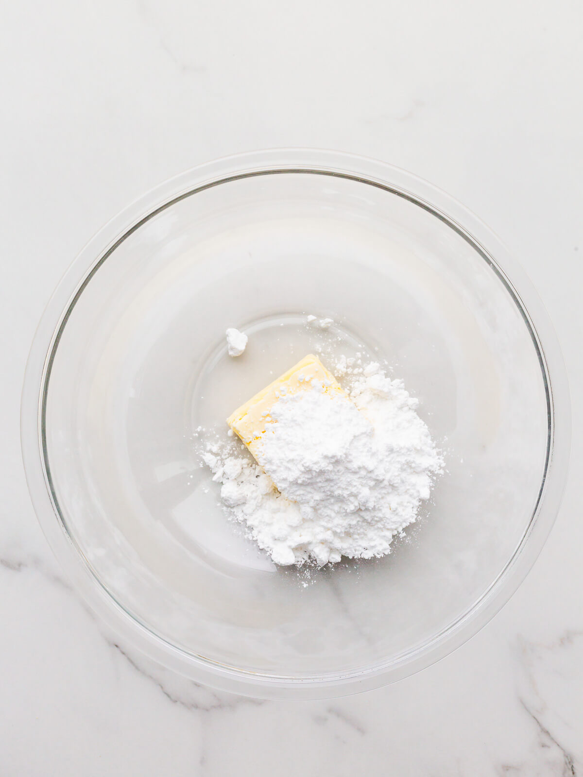 Combining butter and icing sugar in a bowl to make a pistachio tart crust.