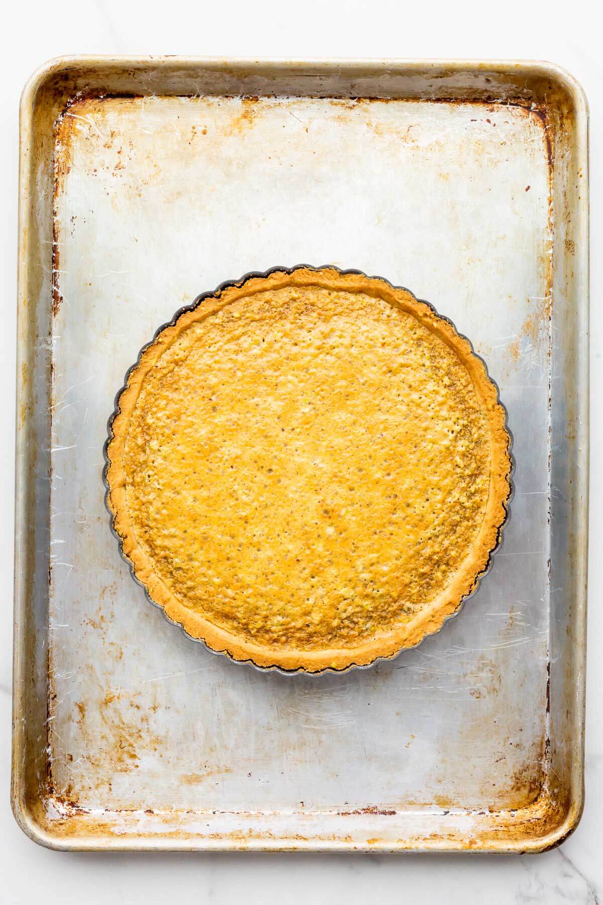 Baked pistachio tart on a sheet pan.
