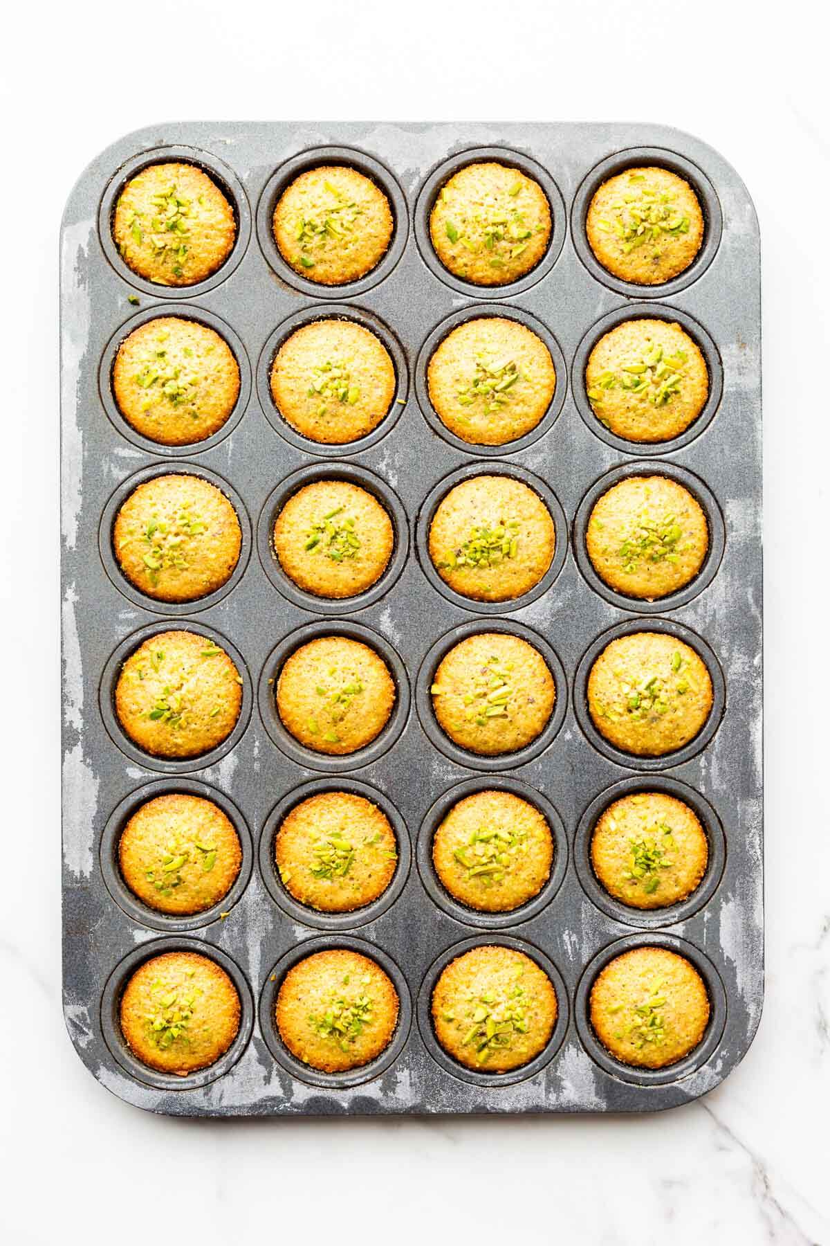 Pistachio financiers after baking in a mini muffin pan.