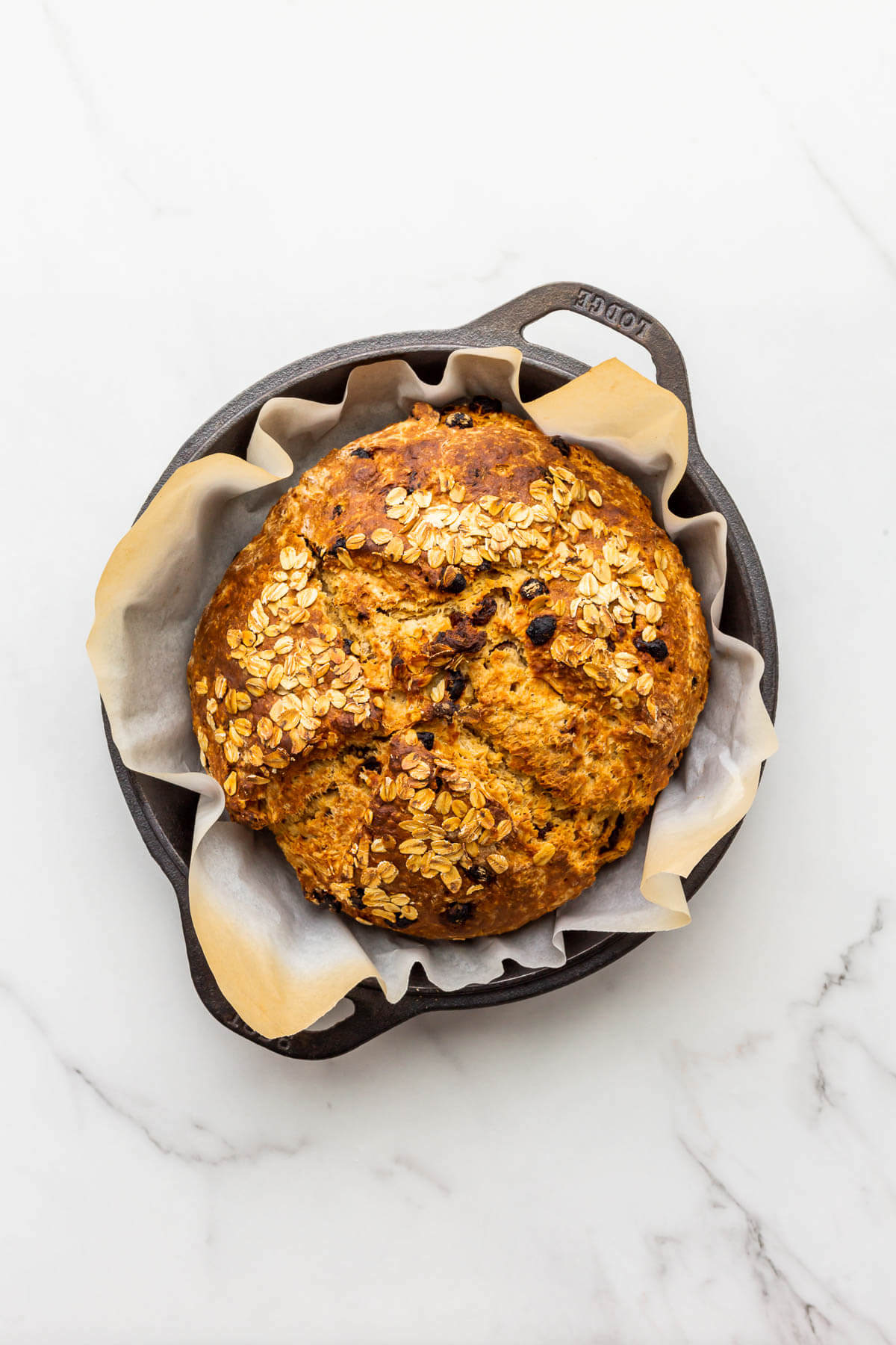 Soda bread with raisins after baking in a cast iron skillet.