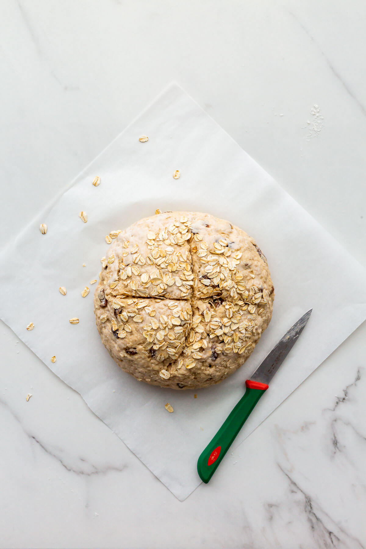 Soda bread topped with oats and scored deeply