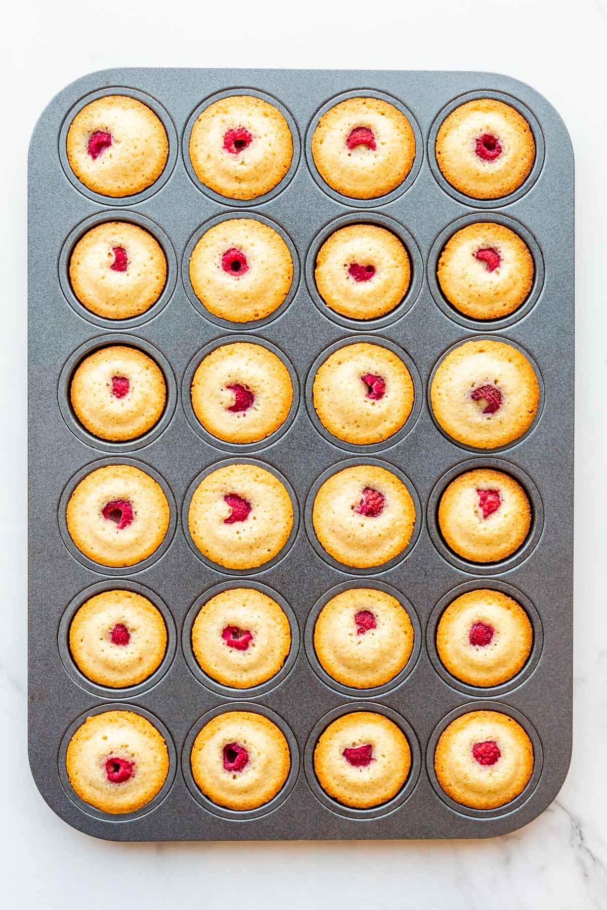 Rapsberry almond financiers after baking in a mini muffin pan.